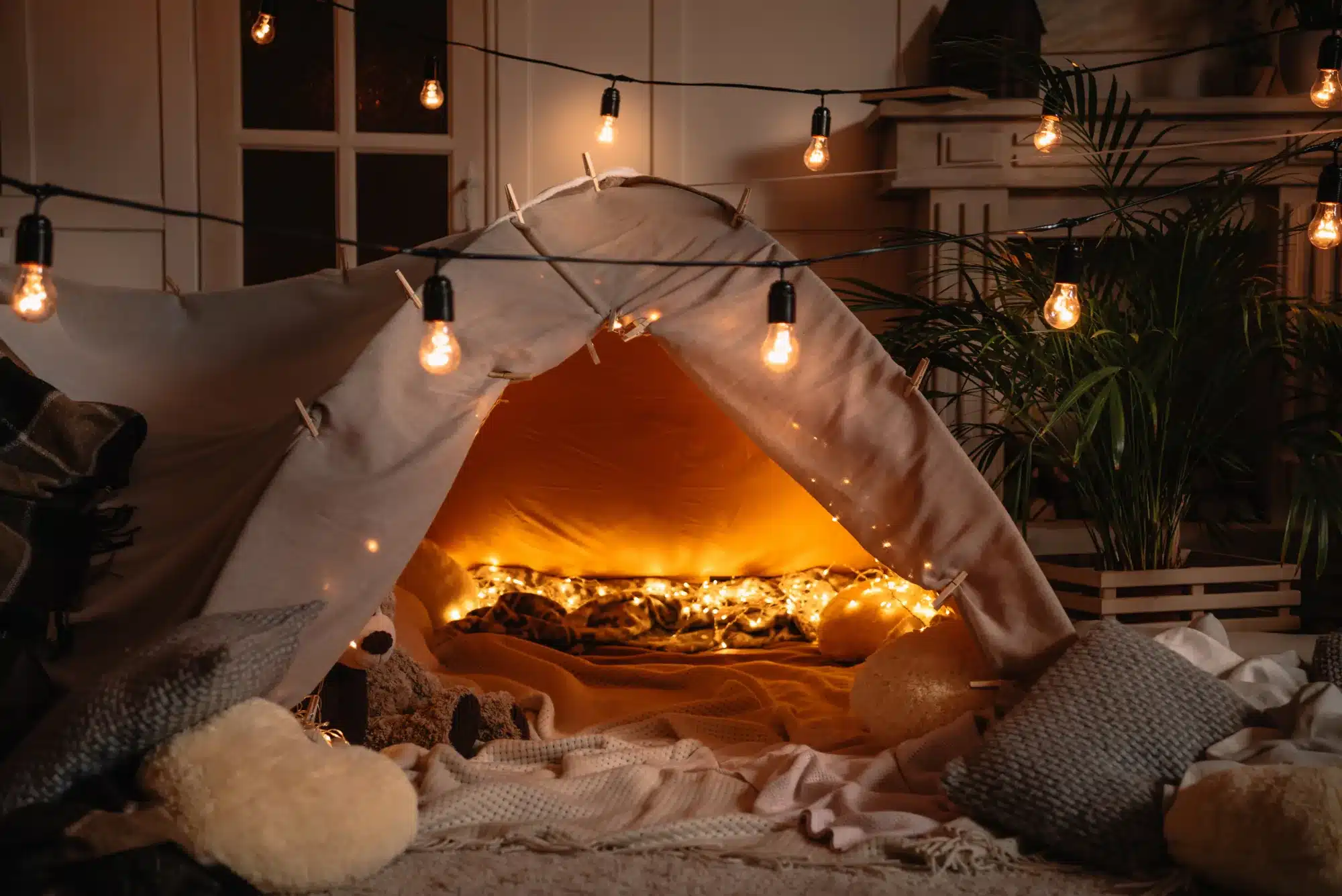 A blanket fort lit with warm string lights. Helping a child feel safe after a frightening event, from a counselor near Tigard, Oregon.