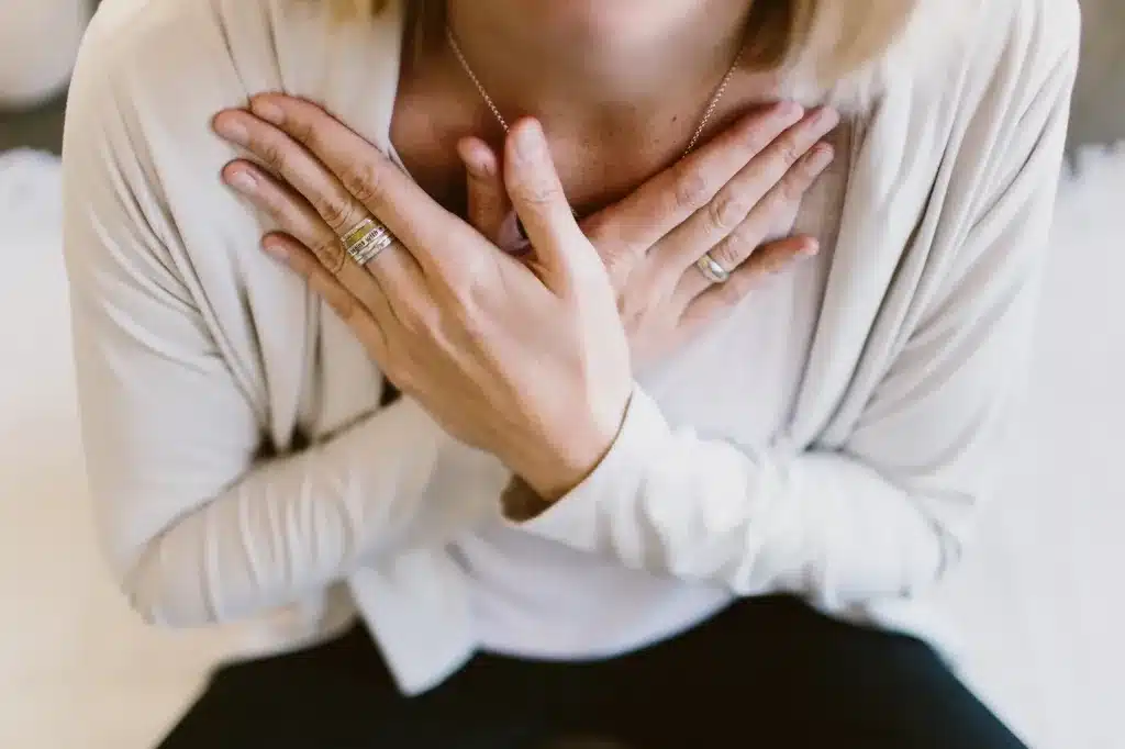 Hands resting crossed on the chest. Somatic trauma therapy near Tigard, Oregon.