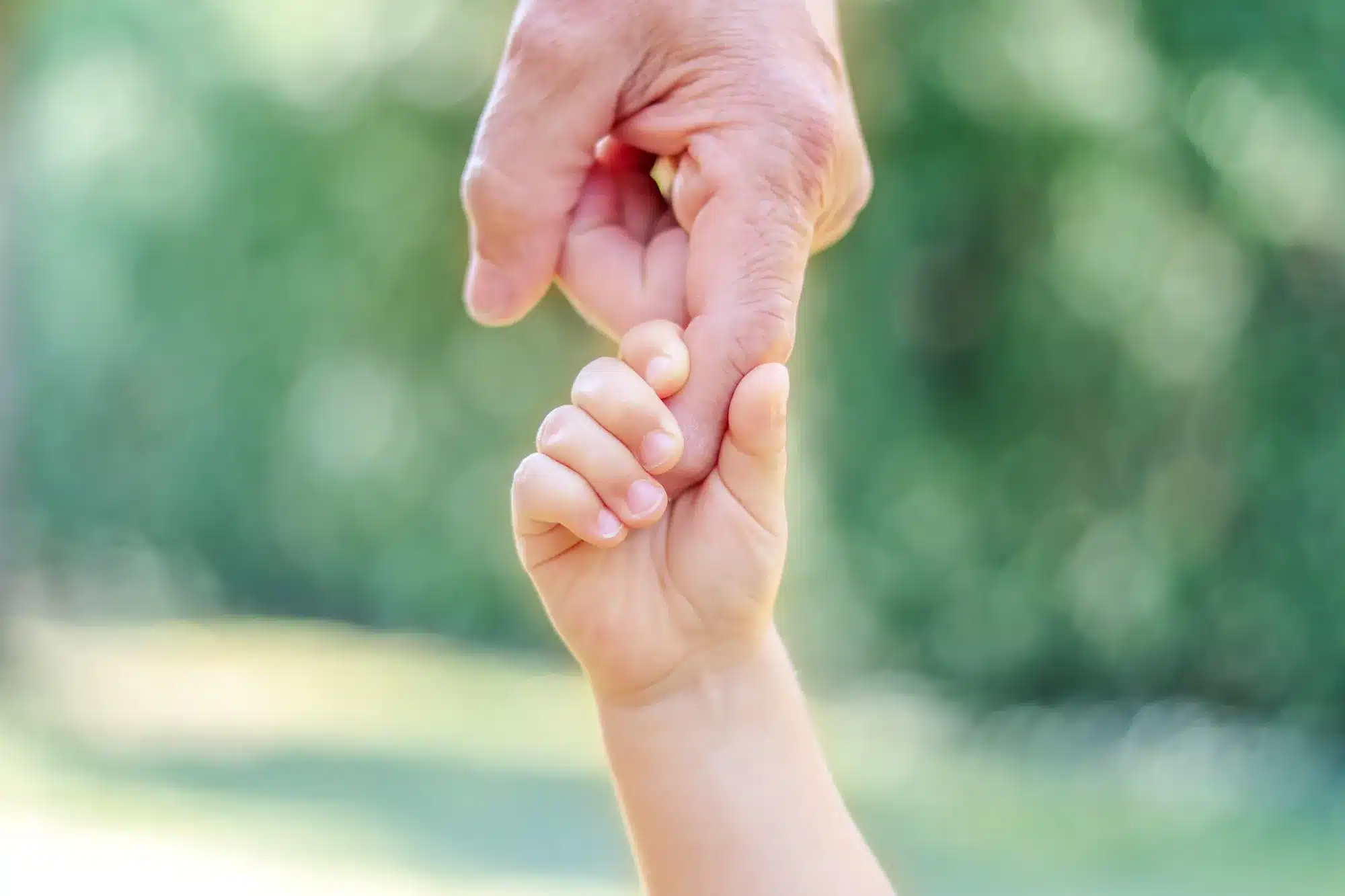 A small hand holding an adult's finger. Helping a child with anxiety, from a counselor near Tigard, Oregon.