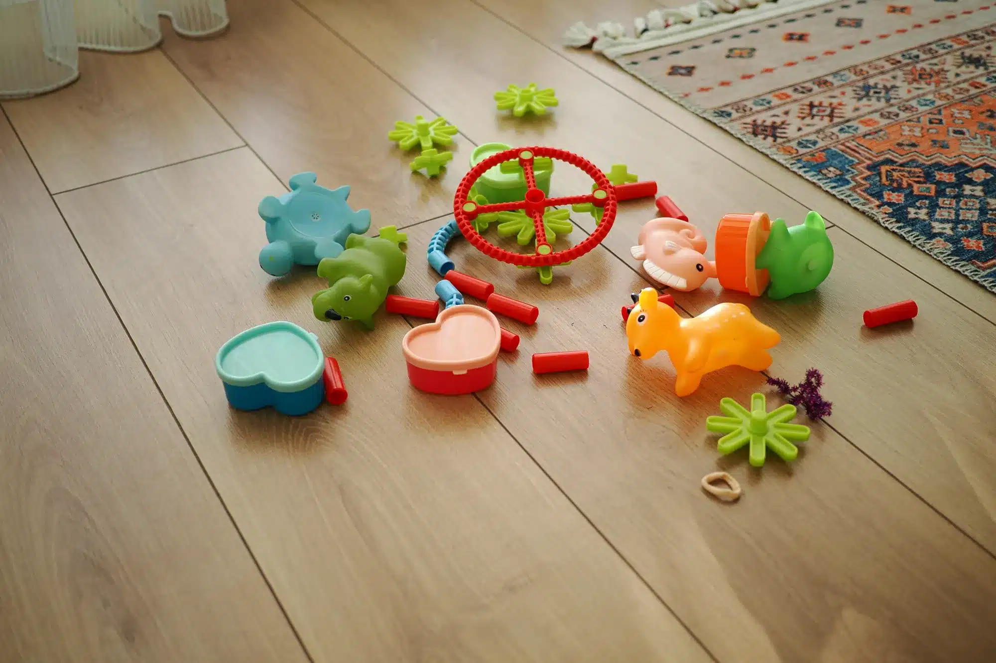 Children's toys scattered across a wooden floor. When tantrums and meltdowns are normal, from a counselor near Tigard, Oregon.
